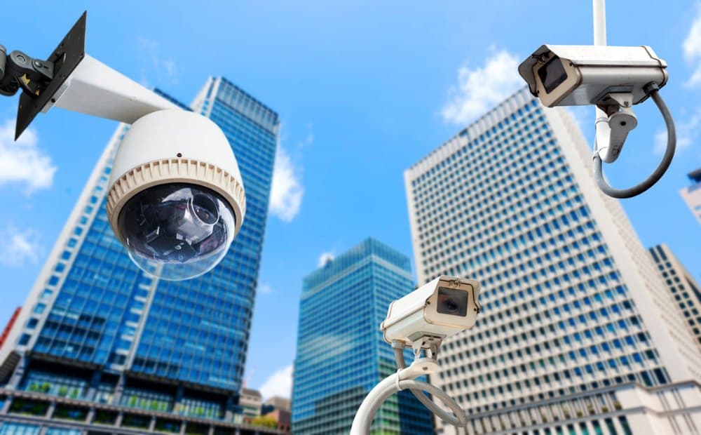 PTZ and bullet cameras covering a commercial campus against city buildings